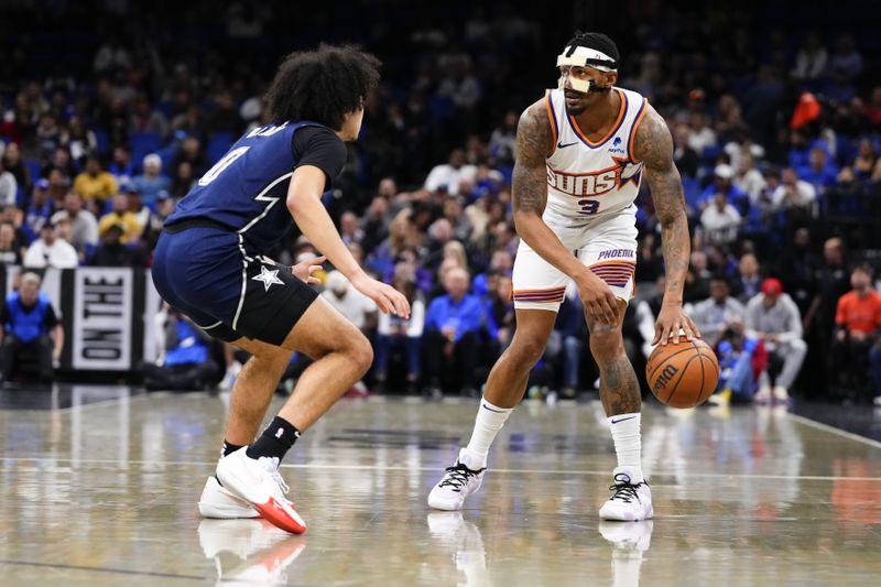 ORLANDO, FLORIDA - JANUARY 28: Bradley Beal #3 of the Phoenix Suns dribbles the ball against Anthony Black #0 of the Orlando Magic during the first quarter at Kia Center on January 28, 2024 in Orlando, Florida. NOTE TO USER: User expressly acknowledges and agrees that, by downloading and or using this photograph, User is consenting to the terms and conditions of the Getty Images License Agreement. (Photo by Rich Storry/Getty Images)