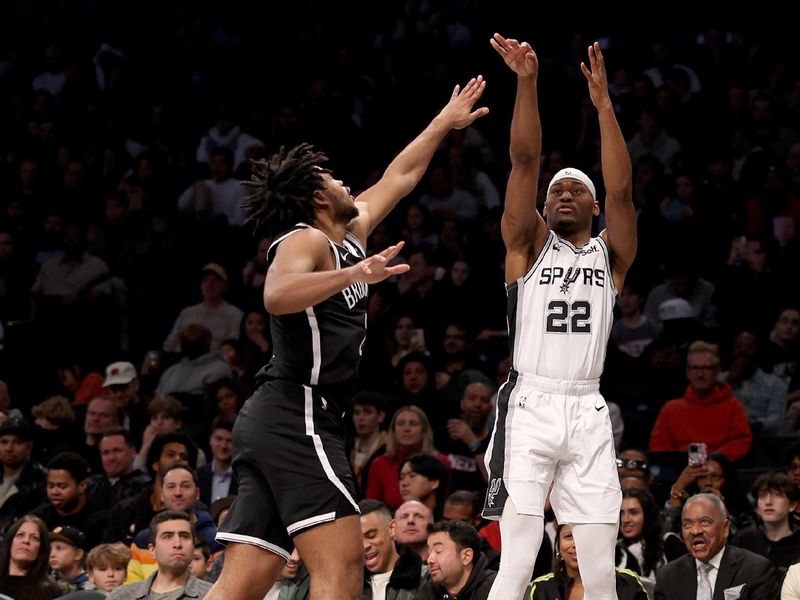 NEW YORK, NEW YORK - FEBRUARY 10: Malaki Branham #22 of the San Antonio Spurs shoots a three point shot as Cam Thomas #24 of the Brooklyn Nets defends in the first half at Barclays Center on February 10, 2024 in the Brooklyn borough of New York City. NOTE TO USER: User expressly acknowledges and agrees that, by downloading and or using this photograph, User is consenting to the terms and conditions of the Getty Images License Agreement. (Photo by Elsa/Getty Images)