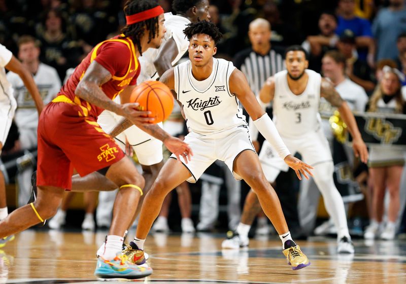 Feb 11, 2025; Orlando, Florida, USA;  Central Florida Knights guard Jordan Ivy-Curry (0) defends Iowa State Cyclones guard Keshon Gilbert (10) at Addition Financial Arena. Mandatory Credit: Russell Lansford-Imagn Images