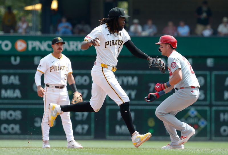 Jul 24, 2024; Pittsburgh, Pennsylvania, USA;  Pittsburgh Pirates shortstop Oneil Cruz (15) throws to first base to complete a double play against St. Louis Cardinals right fielder Lars Nootbaar (21) during the ninth inning at PNC Park. Pittsburgh won 5-0. Mandatory Credit: Charles LeClaire-USA TODAY Sports