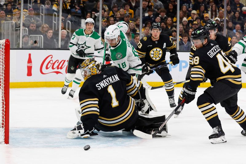 Feb 19, 2024; Boston, Massachusetts, USA; Boston Bruins defenseman Matt Grzelcyk (48) moves to clear a puck out from behing Boston Bruins goaltender Jeremy Swayman (1) as Dallas Stars center Sam Steel (18) looks for it during the second period at TD Garden. Mandatory Credit: Winslow Townson-USA TODAY Sports