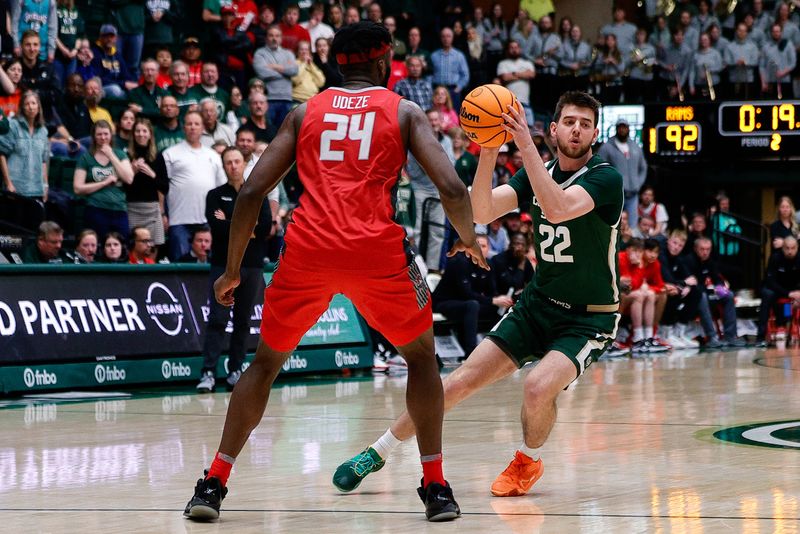 Mar 3, 2023; Fort Collins, Colorado, USA; Colorado State Rams forward Nick Bassett (22) controls the ball as New Mexico Lobos forward Morris Udeze (24) guards in the second half at Moby Arena. Mandatory Credit: Isaiah J. Downing-USA TODAY Sports