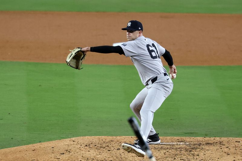 Oct 26, 2024; Los Angeles, California, USA;New York Yankees pitcher Jake Cousins (61) throws a pitch against the Los Angeles Dodgers in the fourth inning for game two of the 2024 MLB World Series at Dodger Stadium. Mandatory Credit: Kiyoshi Mio-Imagn Images