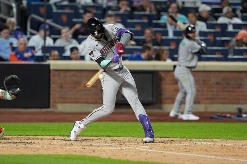 Apr 30, 2025; New York City, New York, USA; Arizona Diamondbacks left fielder Lourdes Gurriel Jr. (12) hits a single against the New York Mets during the seventh inning at Citi Field. Mandatory Credit: Gregory Fisher-Imagn Images
