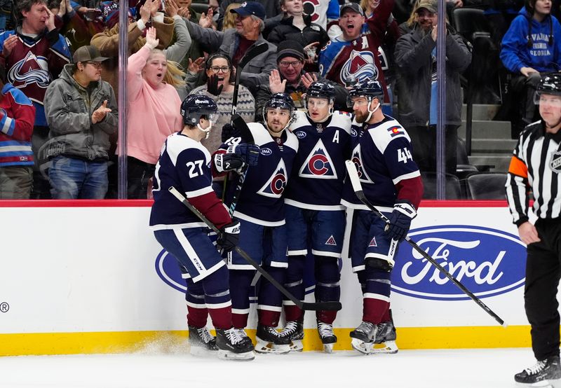 Jan 20, 2025; Denver, Colorado, USA; Colorado Avalanche center Nathan MacKinnon (29) ceblrates his goal with left wing Jonathan Drouin (27), defenseman Samuel Girard (49) and defenseman Calvin de Haan (44) in the second period against the Minnesota Wild at Ball Arena. Mandatory Credit: Ron Chenoy-Imagn Images