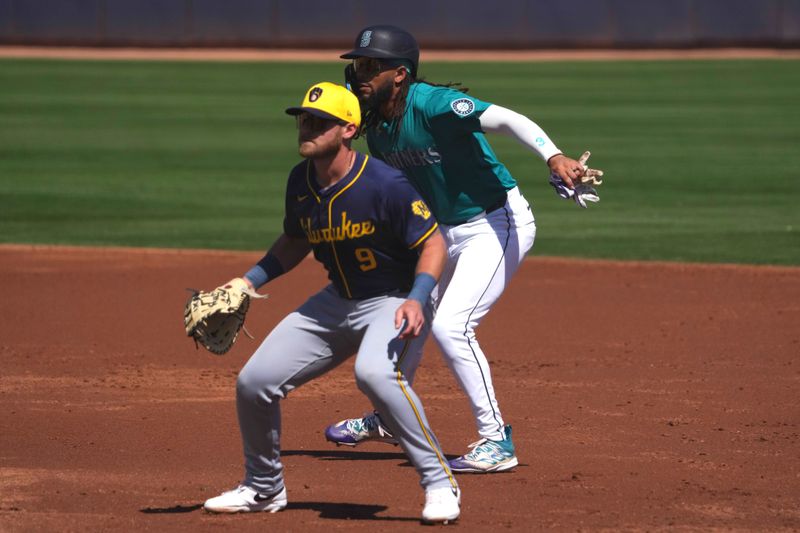 Mar 14, 2024; Peoria, Arizona, USA; Seattle Mariners shortstop J.P. Crawford (3) leads off first base as Milwaukee Brewers first baseman Jake Bauers (9) covers the bag during the third inning at Peoria Sports Complex. Mandatory Credit: Joe Camporeale-USA TODAY Sports