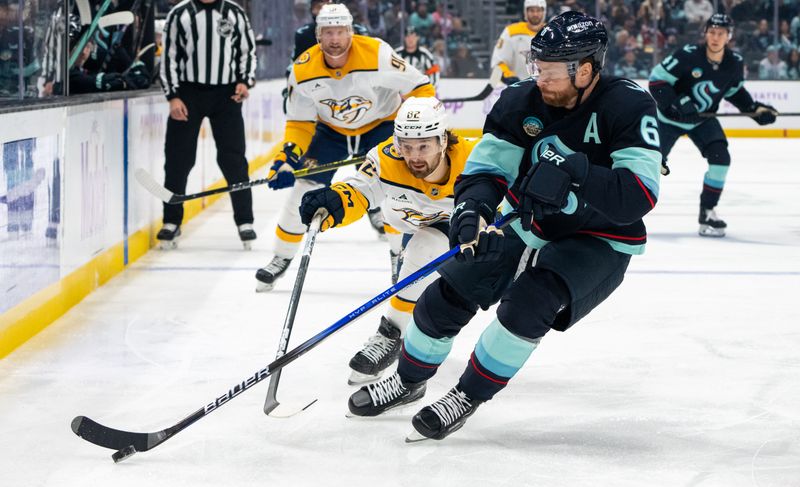 Nov 20, 2024; Seattle, Washington, USA;  Seattle Kraken defenseman Adam Larsson (6) skates against Nashville Predators forward Tommy Novak (82) during the first period at Climate Pledge Arena. Mandatory Credit: Stephen Brashear-Imagn Images