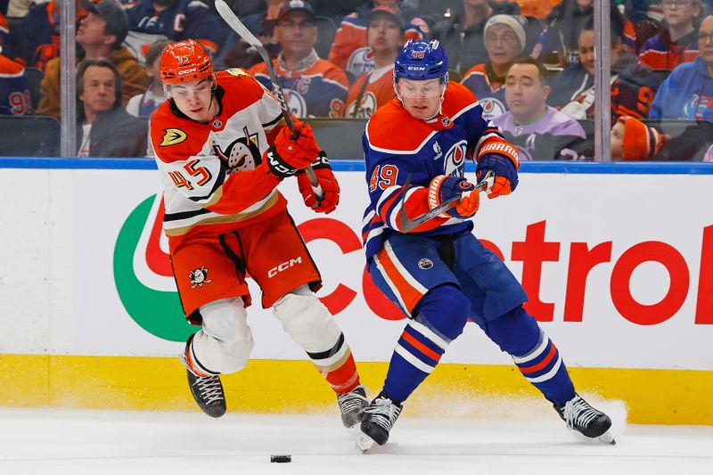 Jan 26, 2026; Edmonton, Alberta, CAN; Edmonton Oilers defensemen Ty Emberson (49) and Anaheim Ducks forward Beckett Sennecke (45) chases a loose puck during the second period at Rogers Place. Mandatory Credit: Perry Nelson-Imagn Images