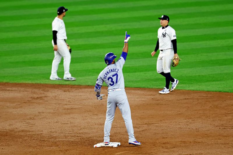 Oct 30, 2024; Bronx, New York, USA; Los Angeles Dodgers outfielder Teoscar Hernandez (37) celebrates after hitting a two run RBI during the fifth inning against the New York Yankees during game five of the 2024 MLB World Series at Yankee Stadium. Mandatory Credit: James Lang-Imagn Images