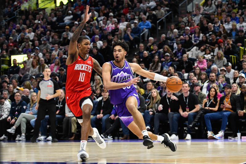 SALT LAKE CITY, UTAH - MARCH 29: Johnny Juzang #33 of the Utah Jazz drives into Jabari Smith Jr. #10 of the Houston Rockets during the second half of a game at Delta Center on March 29, 2024 in Salt Lake City, Utah. NOTE TO USER: User expressly acknowledges and agrees that, by downloading and or using this photograph, User is consenting to the terms and conditions of the Getty Images License Agreement.  (Photo by Alex Goodlett/Getty Images)