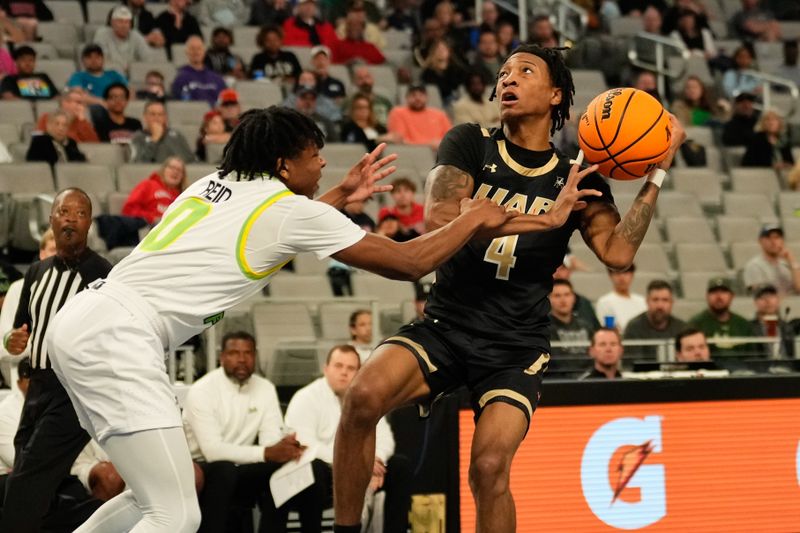 Mar 16, 2024; Fort Worth, TX, USA; UAB Blazers guard Eric Gaines (4) is fouled while driving to the basket by South Florida Bulls guard Jayden Reid (0) during the first half at Dickies Arena. Mandatory Credit: Chris Jones-USA TODAY Sports