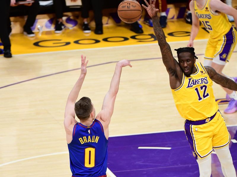 LOS ANGELES, CA - APRIL 25: Christian Braun #0 of the Denver Nuggets shoots the ball while Taurean Prince #12 of the Los Angeles Lakers goes up for the block during the game during Round One Game Three of the 2024 NBA Playoffs on April 25, 2024 at Crypto.Com Arena in Los Angeles, California. NOTE TO USER: User expressly acknowledges and agrees that, by downloading and/or using this Photograph, user is consenting to the terms and conditions of the Getty Images License Agreement. Mandatory Copyright Notice: Copyright 2024 NBAE (Photo by Adam Pantozzi/NBAE via Getty Images)