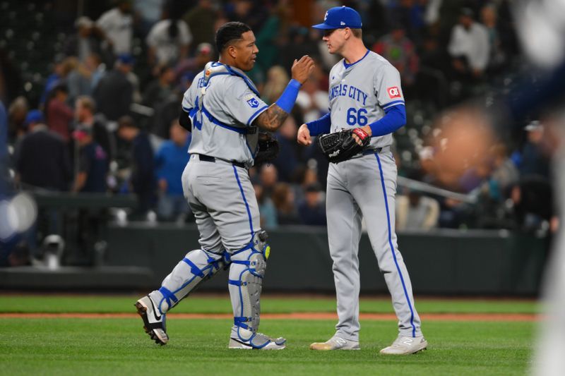 May 14, 2024; Seattle, Washington, USA; Kansas City Royals catcher Salvador Perez (13) and relief pitcher James McArthur (66) celebrate defeating the Seattle Mariners during the ninth inning at T-Mobile Park. Mandatory Credit: Steven Bisig-USA TODAY Sports