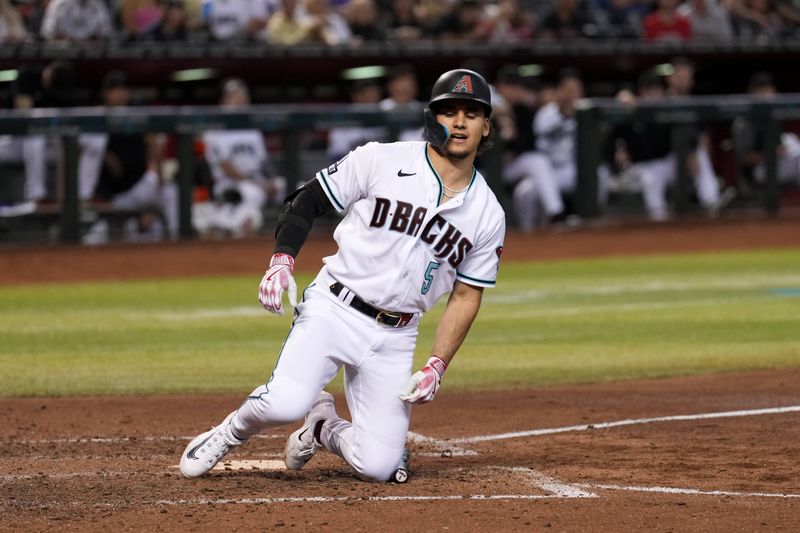 Sep 30, 2023; Phoenix, Arizona, USA; Arizona Diamondbacks center fielder Alek Thomas (5) reacts after getting hit by.a pitch against the Houston Astros during the seventh inning at Chase Field. Mandatory Credit: Joe Camporeale-USA TODAY Sports