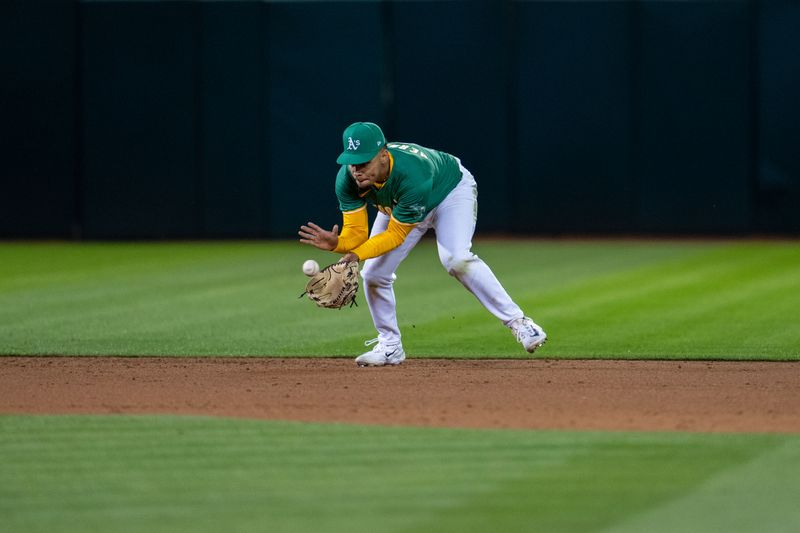 Apr 30, 2024; Oakland, California, USA;  Oakland Athletics shortstop Darell Hernaiz (2) fields a ground ball against the Pittsburgh Pirates during the sixth inning at Oakland-Alameda County Coliseum. Mandatory Credit: Neville E. Guard-USA TODAY Sports