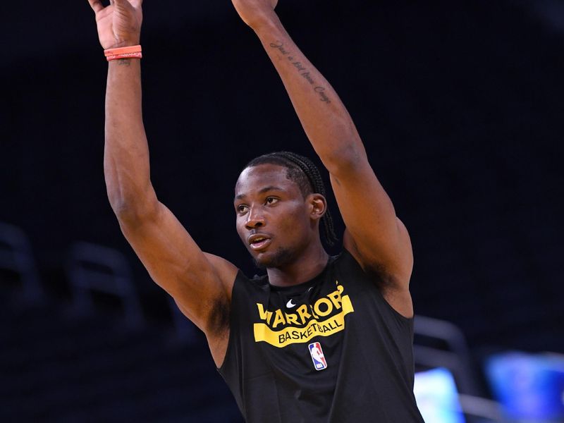 SAN FRANCISCO, CA - NOVEMBER 7: Jonathan Kuminga #00 of the Golden State Warriors warms up before the game against the Sacramento Kings on November 7, 2022 at Chase Center in San Francisco, California. NOTE TO USER: User expressly acknowledges and agrees that, by downloading and or using this photograph, user is consenting to the terms and conditions of Getty Images License Agreement. Mandatory Copyright Notice: Copyright 2022 NBAE (Photo by Noah Graham/NBAE via Getty Images)