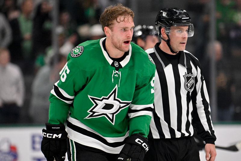 Nov 18, 2025; Dallas, Texas, USA; Dallas Stars right wing Mikko Rantanen (96) is led off the ice after he receives a game misconduct penalty for boarding on New York Islanders defenseman Alexander Romanov (not pictured) during the third period at the American Airlines Center. Mandatory Credit: Jerome Miron-Imagn Images