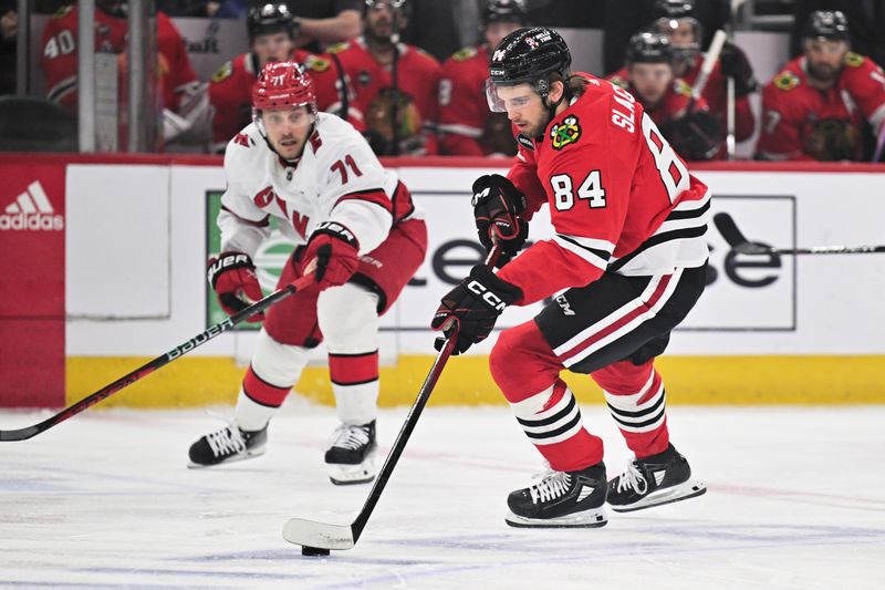 Apr 14, 2024; Chicago, Illinois, USA; Chicago Blackhawks forward Landon Slaggert (84) controls the puck in the first period against the Carolina Hurricanes at United Center. Mandatory Credit: Jamie Sabau-USA TODAY Sports