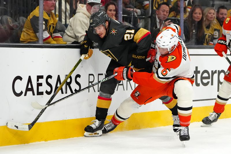 Oct 13, 2024; Las Vegas, Nevada, USA; Anaheim Ducks defenseman Brian Dumoulin (6) checks Vegas Golden Knights center Brett Howden (21) during the second period at T-Mobile Arena. Mandatory Credit: Stephen R. Sylvanie-Imagn Images