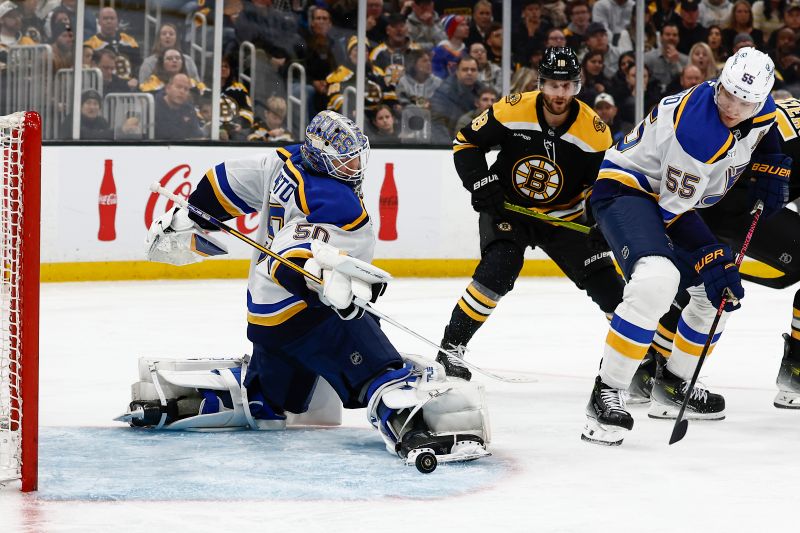 Nov 16, 2024; Boston, Massachusetts, USA; St. Louis Blues goaltender Jordan Binnington (50) makes a skate save against the Boston Bruins as defenseman Colton Parayko (55) looks on during the third period at TD Garden. Mandatory Credit: Winslow Townson-Imagn Images