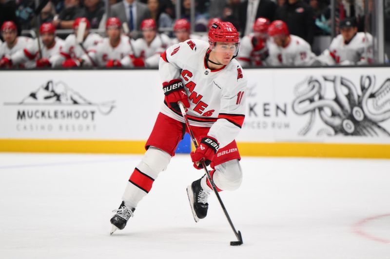 Oct 26, 2024; Seattle, Washington, USA; Carolina Hurricanes center Jack Drury (18) advances the puck against the Seattle Kraken during the second period at Climate Pledge Arena. Mandatory Credit: Steven Bisig-Imagn Images