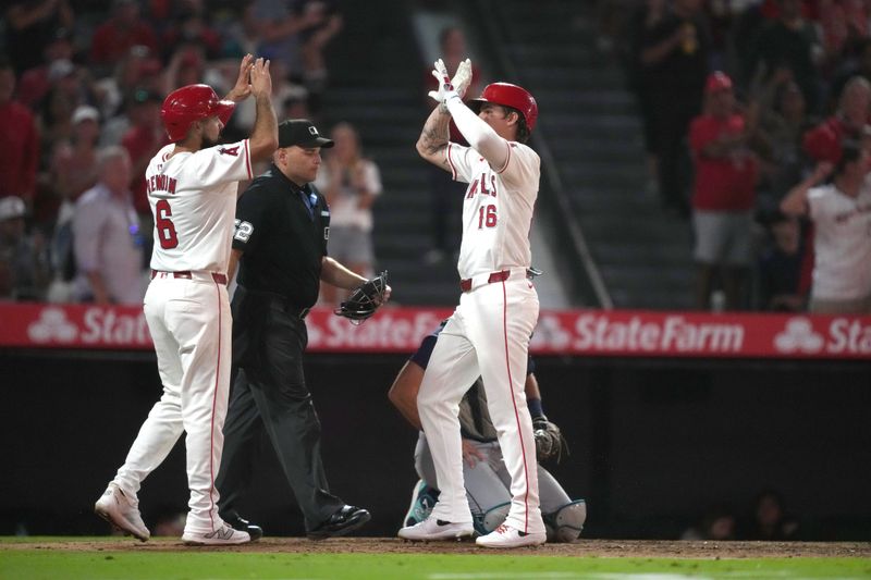 Aug 31, 2024; Anaheim, California, USA; Los Angeles Angels center fielder Mickey Moniak (16) celebrates with third baseman Anthony Rendon (6) after hitting a two-run home run in the seventh inning against the Seattle Mariners at Angel Stadium. Mandatory Credit: Kirby Lee-USA TODAY Sports