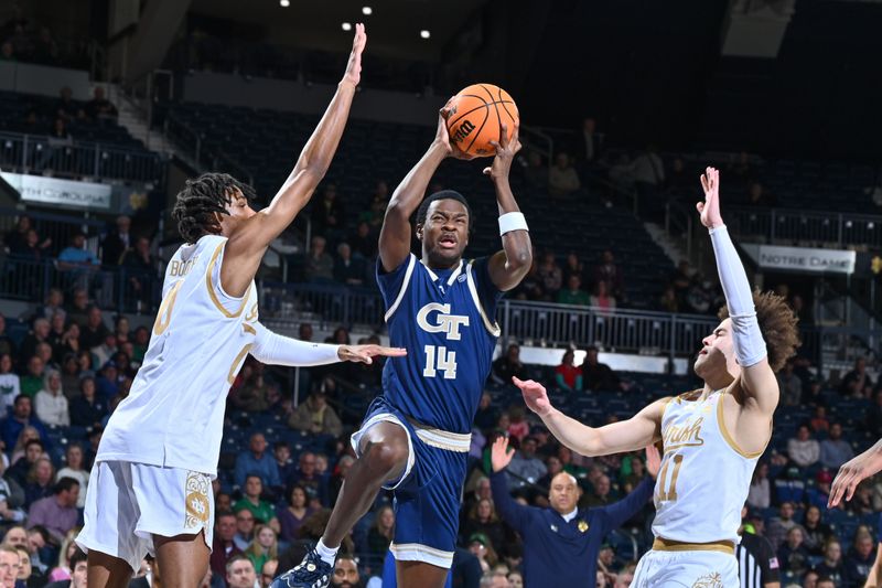 Feb 14, 2024; South Bend, Indiana, USA; Georgia Tech Yellow Jackets guard Kowacie Reeves, Jr. (14) goes up for a shot between Notre Dame Fighting Irish forward Carey Booth (0) and guard Braeden Shrewsberry (11) in the first half at the Purcell Pavilion. Mandatory Credit: Matt Cashore-USA TODAY Sports