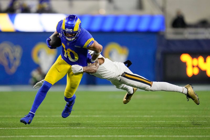 Los Angeles Rams wide receiver Cooper Kupp (10) is tackled by New Orleans Saints cornerback Alontae Taylor during the second half of an NFL football game Thursday, Dec. 21, 2023, in Inglewood, Calif. (AP Photo/Ashley Landis)