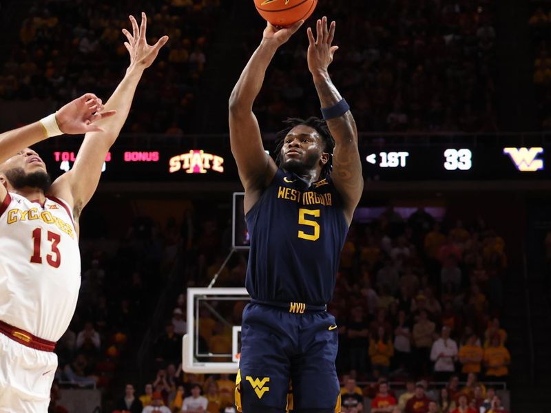 Feb 27, 2023; Ames, Iowa, USA; West Virginia Mountaineers guard Joe Toussaint (5) shoots over Iowa State Cyclones guard Jaren Holmes (13) during the first half at James H. Hilton Coliseum. Mandatory Credit: Reese Strickland-USA TODAY Sports