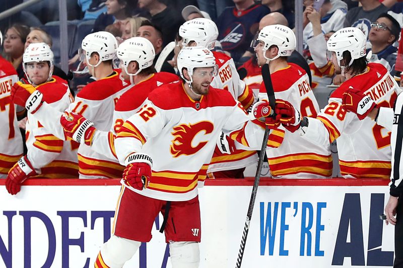 Apr 4, 2024; Winnipeg, Manitoba, CAN; Calgary Flames defenseman Daniil Miromanov (62) celebrates his second period goal against the Winnipeg Jets at Canada Life Centre. Mandatory Credit: James Carey Lauder-USA TODAY Sports