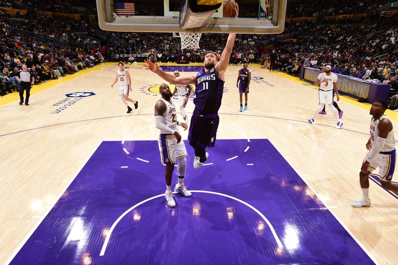 LOS ANGELES, CA - OCTOBER 26: Domantas Sabonis #11 of the Sacramento Kings dunks the ball during the game against the Los Angeles Lakers on October 26, 2024 at Crypto.Com Arena in Los Angeles, California. NOTE TO USER: User expressly acknowledges and agrees that, by downloading and/or using this Photograph, user is consenting to the terms and conditions of the Getty Images License Agreement. Mandatory Copyright Notice: Copyright 2024 NBAE (Photo by Adam Pantozzi/NBAE via Getty Images)