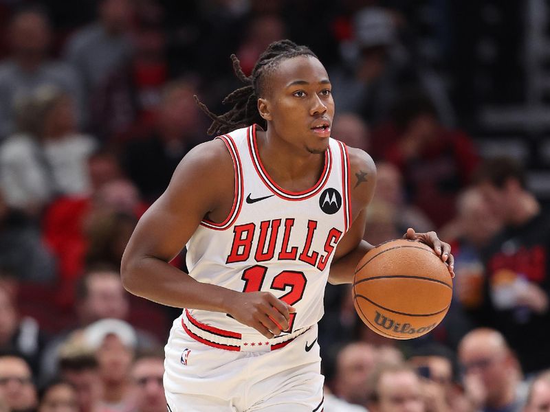 CHICAGO, ILLINOIS - NOVEMBER 06: Ayo Dosunmu #12 of the Chicago Bulls dribbles up the court against the Utah Jazz during the first half at the United Center on November 06, 2023 in Chicago, Illinois. NOTE TO USER: User expressly acknowledges and agrees that, by downloading and or using this photograph, User is consenting to the terms and conditions of the Getty Images License Agreement. (Photo by Michael Reaves/Getty Images)