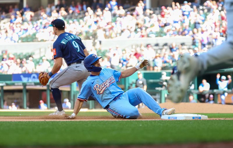 May 4, 2025; Arlington, Texas, USA;  Texas Rangers center fielder Josh Smith (8) slides into third base with an rbi triple during the eighth inning against the Seattle Mariners at Globe Life Field. Mandatory Credit: Kevin Jairaj-Imagn Images