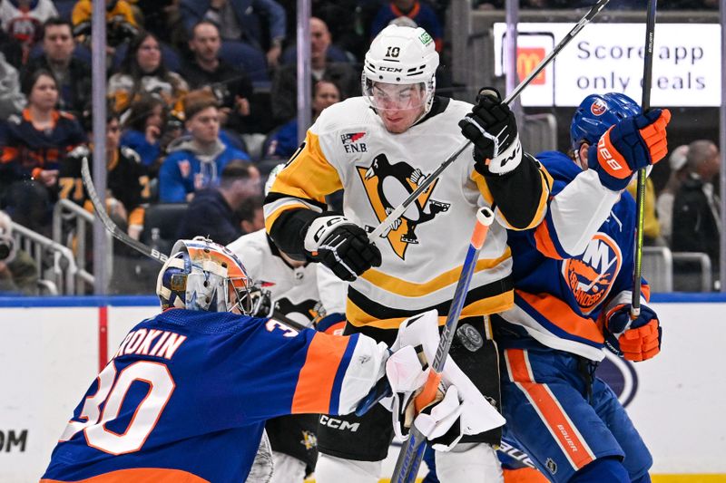 Apr 17, 2024; Elmont, New York, USA;  New York Islanders goaltender Ilya Sorokin (30) makes a blocker save in front of Pittsburgh Penguins left wing Drew O'Connor (10) during the third period at UBS Arena. Mandatory Credit: Dennis Schneidler-USA TODAY Sports