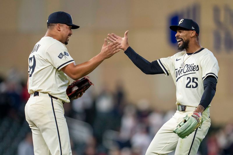 Apr 22, 2025; Minneapolis, Minnesota, USA; Minnesota Twins relief pitcher Jhoan Duran (59) and Minnesota Twins center fielder Byron Buxton (25) celebrate after defeating the Chicago White Sox at Target Field. Mandatory Credit: Jesse Johnson-Imagn Images