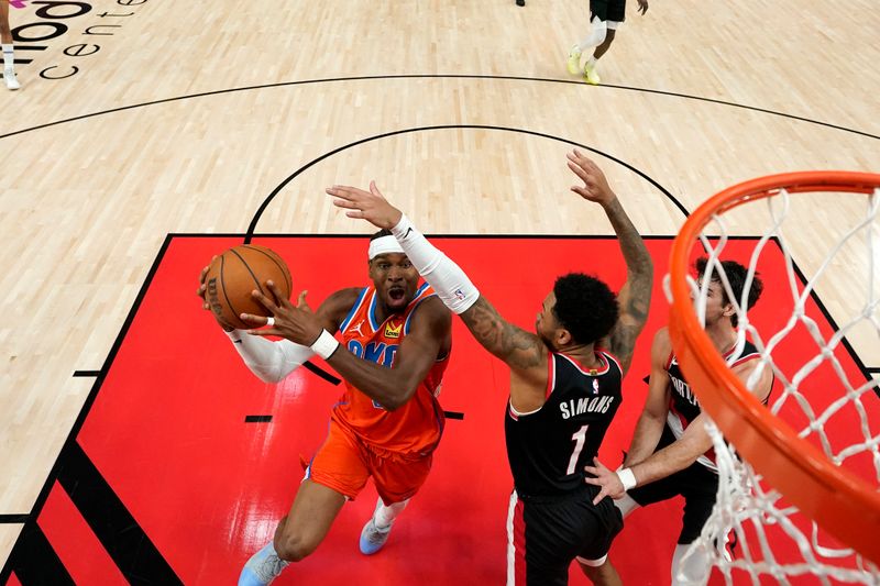 PORTLAND, OREGON - NOVEMBER 01: Shai Gilgeous-Alexander #2 of the Oklahoma City Thunder drives to the basket against Anfernee Simons #1 of the Portland Trail Blazers during the first half at Moda Center on November 01, 2024 in Portland, Oregon. NOTE TO USER: User expressly acknowledges and agrees that, by downloading and or using this photograph, User is consenting to the terms and conditions of the Getty Images License Agreement. (Photo by Soobum Im/Getty Images)