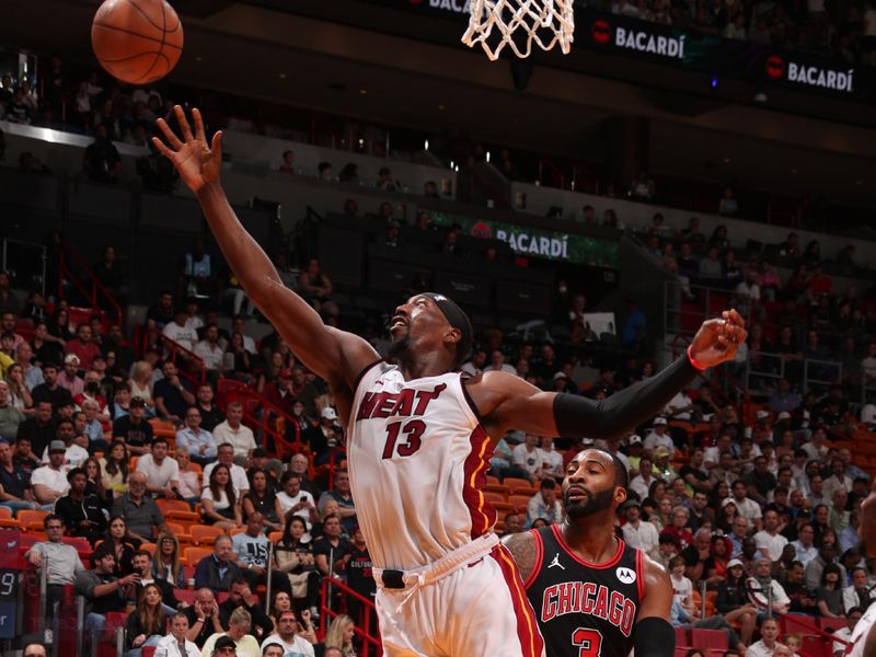 MIAMI, FL - APRIL 19: Bam Adebayo #13 of the Miami Heat grabs the rebound during the game against the Chicago Bulls during the 2024 Play-In Tournament on April 19, 2024 at Kaseya Center in Miami, Florida. NOTE TO USER: User expressly acknowledges and agrees that, by downloading and or using this Photograph, user is consenting to the terms and conditions of the Getty Images License Agreement. Mandatory Copyright Notice: Copyright 2024 NBAE (Photo by Issac Baldizon/NBAE via Getty Images)