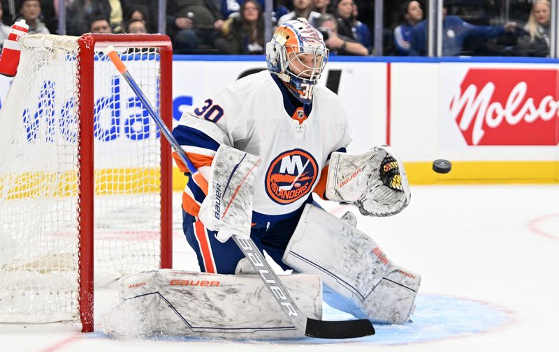 Feb 5, 2024; Toronto, Ontario, CAN;  New York Islanders goalie Ilya Sorokin (30) makes a save against the Toronto Maple Leafs in the third period at Scotiabank Arena. Mandatory Credit: Dan Hamilton-USA TODAY Sports