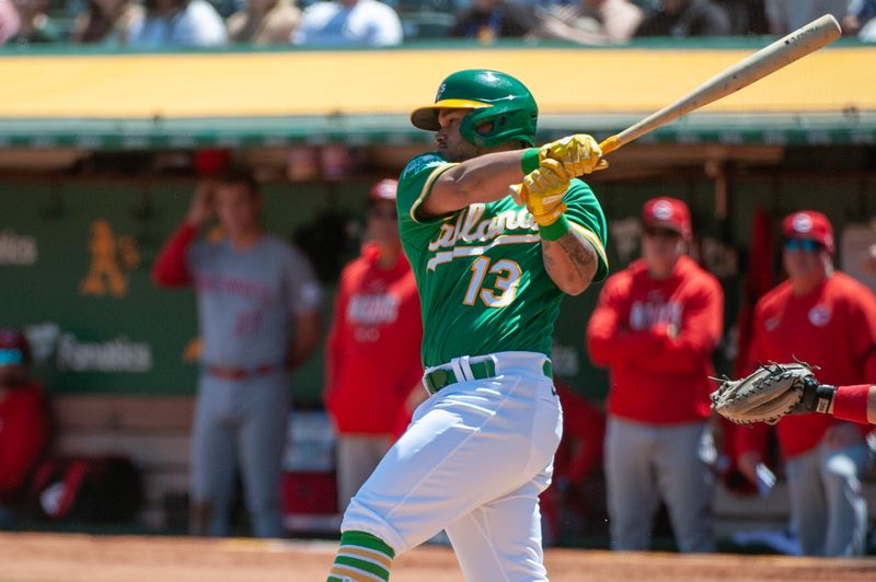 Apr 29, 2023; Oakland, California, USA; Oakland Athletics second baseman Jordan Diaz (13) hits an rbi single during the second inning against the Cincinnati Reds at RingCentral Coliseum. Mandatory Credit: Ed Szczepanski-USA TODAY Sports