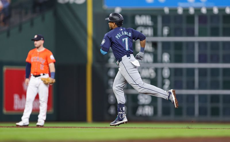 May 3, 2024; Houston, Texas, USA; Houston Astros third baseman Alex Bregman (2) looks on as Seattle Mariners second baseman Jorge Polanco (7) rounds the bases after hitting a home run during the third inning at Minute Maid Park. Mandatory Credit: Troy Taormina-USA TODAY Sports