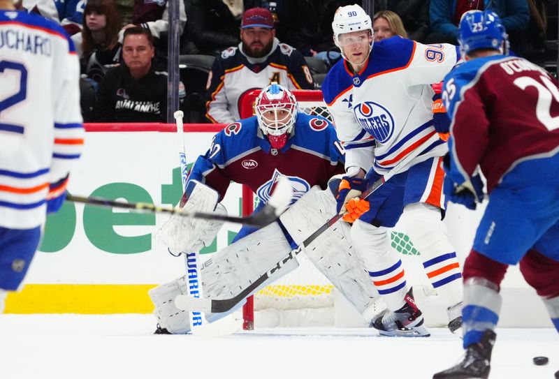 Nov 30, 2024; Denver, Colorado, USA; Colorado Avalanche center Nathan MacKinnon (29) and Edmonton Oilers right wing Corey Perry (90) during the second period at Ball Arena. Mandatory Credit: Ron Chenoy-Imagn Images