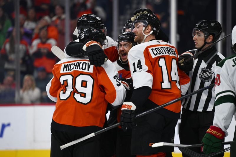 Oct 26, 2024; Philadelphia, Pennsylvania, USA; Philadelphia Flyers right wing Travis Konecny (11) reacts as teammates celebrate a goal from defenseman Rasmus Ristolainen (55) against the Minnesota Wild in the third period at Wells Fargo Center. Mandatory Credit: Kyle Ross-Imagn Images