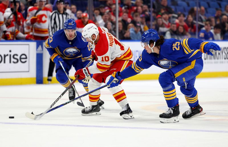 Oct 19, 2023; Buffalo, New York, USA;  Buffalo Sabres defenseman Owen Power (25) knocks the puck off the stick of Calgary Flames center Jonathan Huberdeau (10) during the first period at KeyBank Center. Mandatory Credit: Timothy T. Ludwig-USA TODAY Sports