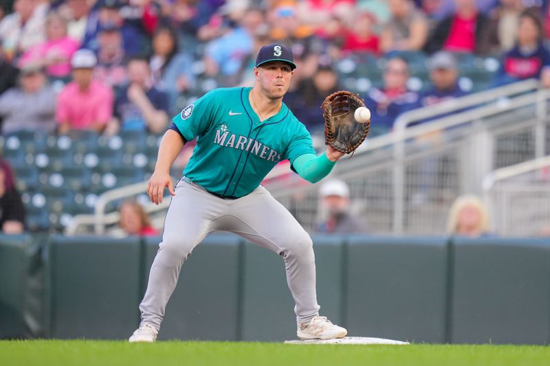 May 6, 2024; Minneapolis, Minnesota, USA; Seattle Mariners first baseman Ty France (23) catches the ball for an out against the Minnesota Twins in the third inning at Target Field. Mandatory Credit: Brad Rempel-USA TODAY Sports