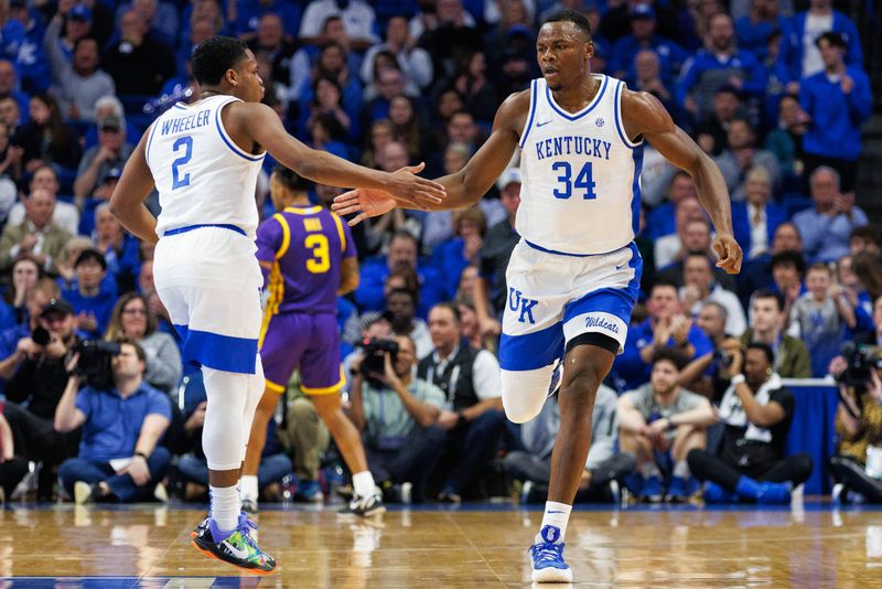 Jan 3, 2023; Lexington, Kentucky, USA; Kentucky Wildcats forward Oscar Tshiebwe (34) celebrates with guard Sahvir Wheeler (2) during the first half against the LSU Tigers at Rupp Arena at Central Bank Center. Mandatory Credit: Jordan Prather-USA TODAY Sports