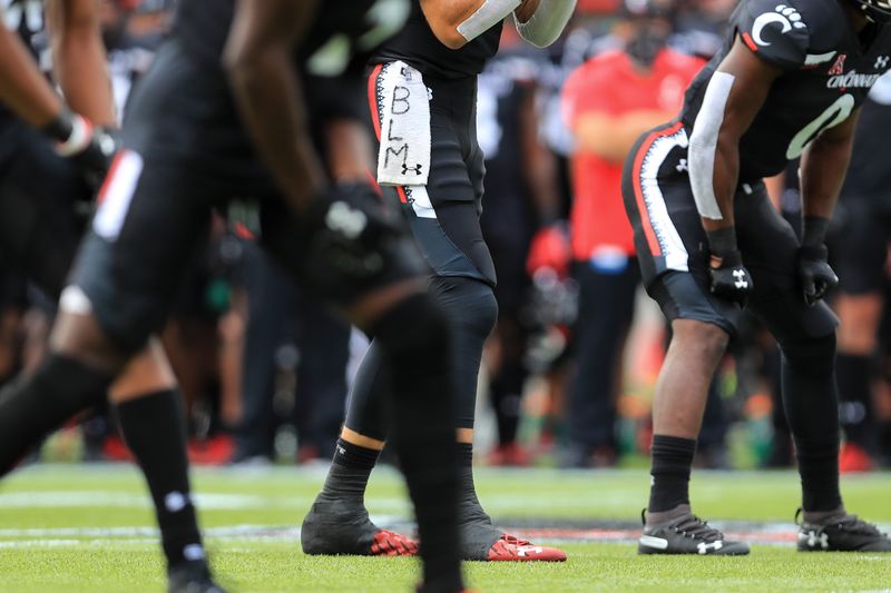 Sep 26, 2020; Cincinnati, Ohio, USA; A view of the Under Armor towel with the letters representing Black Lives Matter, worn by Cincinnati Bearcats quarterback Desmond Ridder (9) in the game against the Army Black Knights in the first half at Nippert Stadium. Mandatory Credit: Aaron Doster-USA TODAY Sports