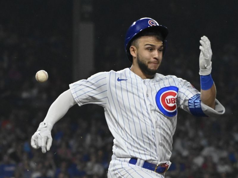 Jun 29, 2023; Chicago, Illinois, USA; Chicago Cubs third baseman Nick Madrigal (1) tries to run out the throw to  first base during the ninth inning against the Philadelphia Phillies at Wrigley Field. Mandatory Credit: Matt Marton-USA TODAY Sports