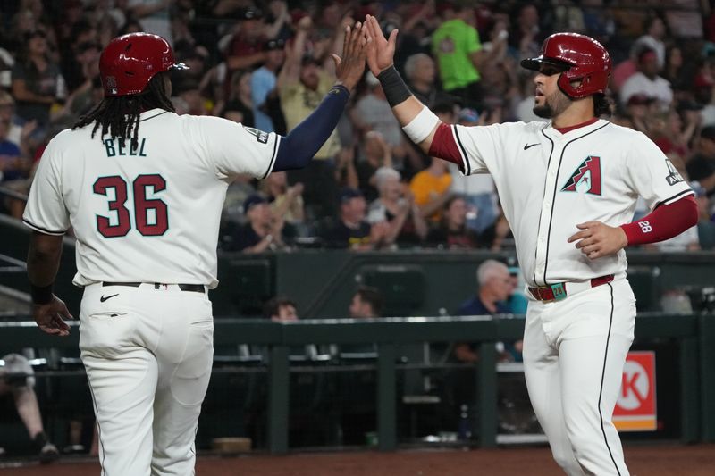 Aug 11, 2024; Phoenix, Arizona, USA; Philadelphia Phillies third base Alec Bohm (28) and first base Josh Bell (36) celebrate after scoring against the Philadelphia Phillies in the third inning at Chase Field. Mandatory Credit: Rick Scuteri-USA TODAY Sports