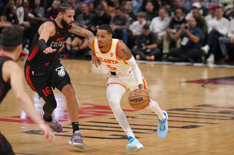 MIAMI, FL - JANUARY 19: Dejounte Murray #5 of the Atlanta Hawks dribbles the ball during the game against the Miami Heat on January 19, 2024 at Kaseya Center in Miami, Florida. NOTE TO USER: User expressly acknowledges and agrees that, by downloading and or using this Photograph, user is consenting to the terms and conditions of the Getty Images License Agreement. Mandatory Copyright Notice: Copyright 2024 NBAE (Photo by Eric Espada/NBAE via Getty Images)