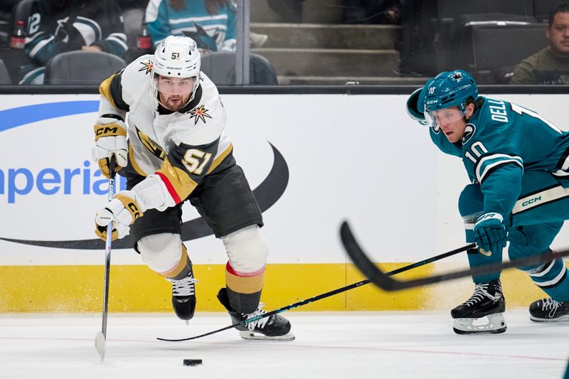 Sep 26, 2025; San Jose, California, USA; Vegas Golden Knights defenseman Lukas Cormier (51) plays the puck against San Jose Sharks forward Ty Dellandrea (10) during the first period at SAP Center at San Jose. Mandatory Credit: Robert Edwards-Imagn Images
